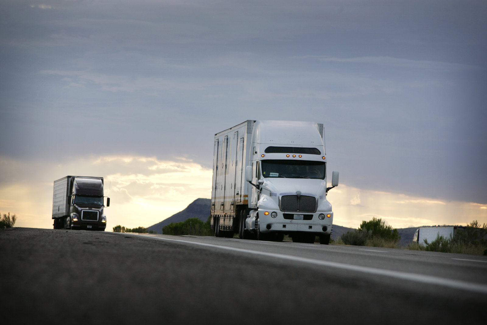 2 trucks on country road