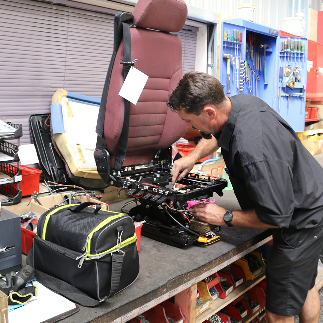 man fixing a truck seat